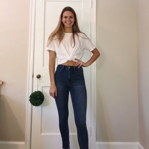 Medium/dark wash jeans with slight ankle fringe.